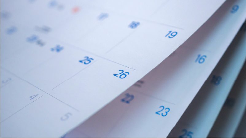 Close-up of calendar flipping pages